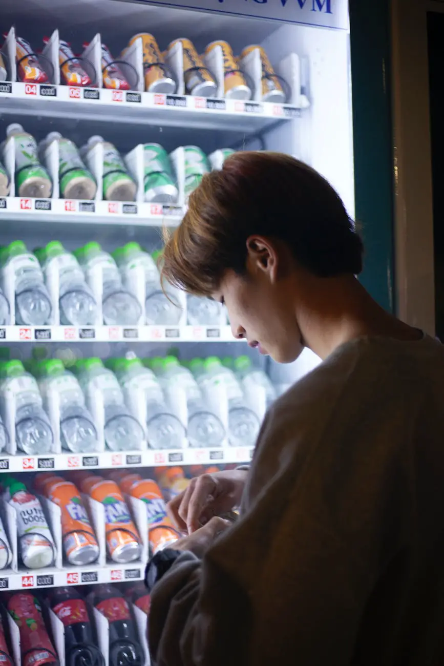 a man standing on a vending machine with drinks