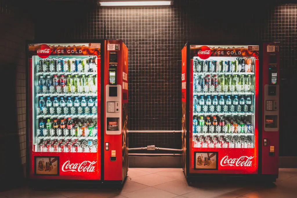 coca cola vending machine near a wall