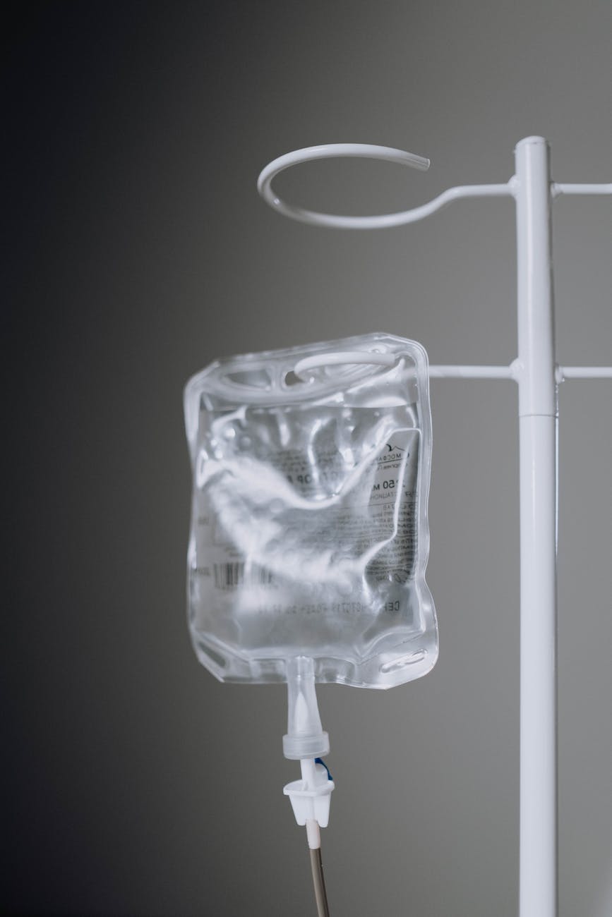 close up photo of an iv fluid hanging on pole