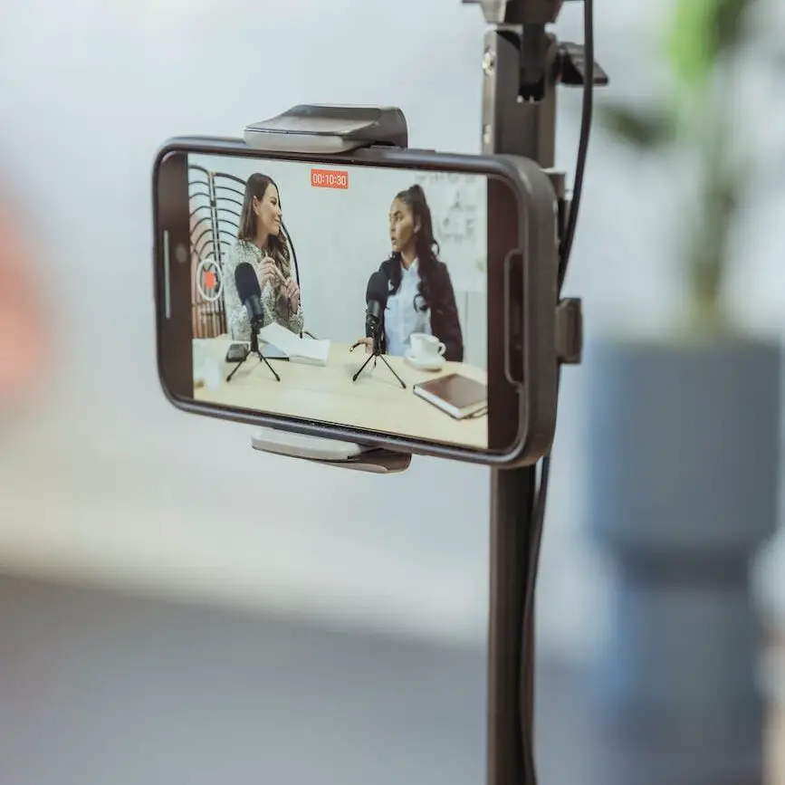 smartphone on tripod recording vlog with young multiethnic ladies